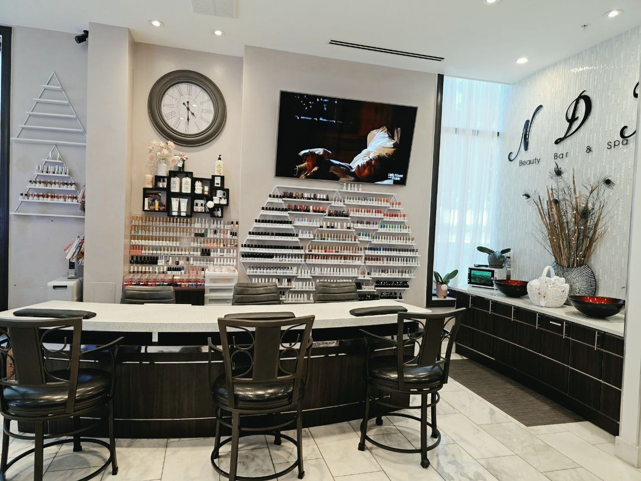 Inside Nails Du Jour Beauty Bar, with manicure stations and nail polish displays
